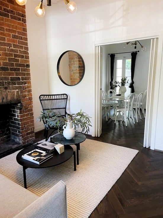 Round mirror bringing out the rough textured brick wall