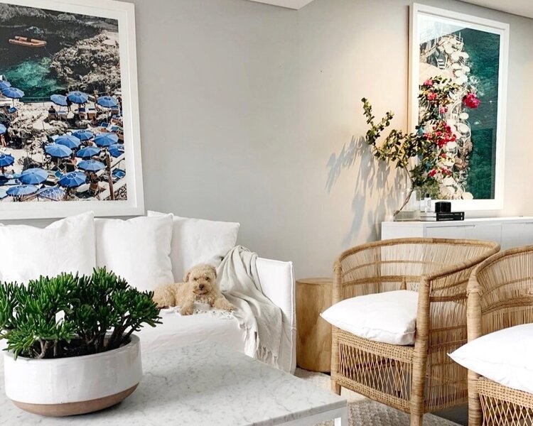 Greta’s own lounge room features statement artworks and crisp, white tones throughout.